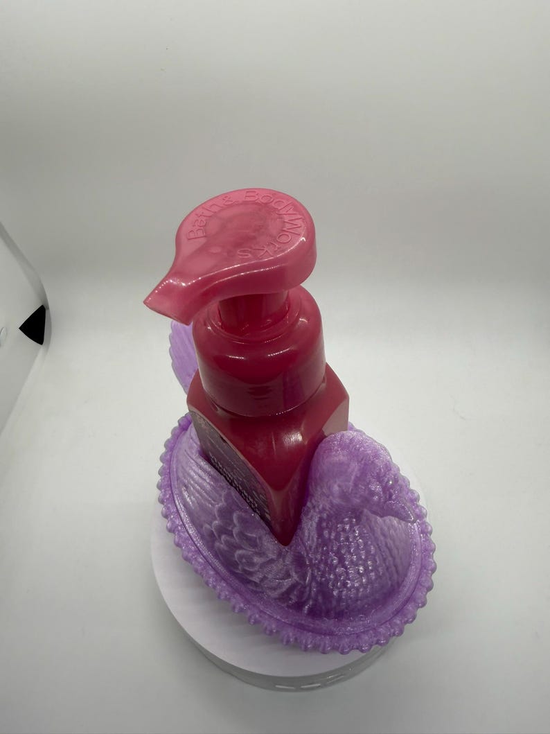 May include: A white ceramic mug with a black handle and the text "But First, Coffee" in a black, handwritten-style font. The mug is on a white surface.