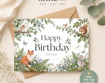 May include: A rectangular birthday greeting card featuring a watercolor illustration of a forest scene with a fox, a rabbit, an owl, a squirrel, and various woodland plants. The text reads Happy Birthday To You in dark green lettering.