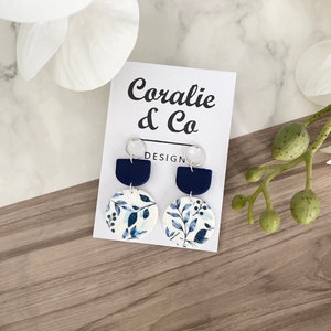 Handmade earrings // polymer clay and sterling silver // navy blue and white floral leaf design drop earrings