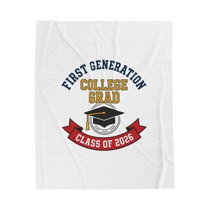 May include: White blanket featuring the text "FIRST GENERATION COLLEGE GRAD" in navy and gold. A black graduation cap is centered below the text, with a red banner that reads "CLASS OF 2026".