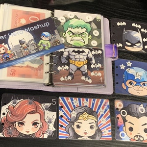 May include: A collection of superhero themed cards featuring characters such as Batman, Wonder Woman, Captain America, Hulk, and Spiderman. The cards are in a binder with a title card that says "Super Hero Mashup".