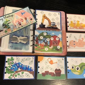 May include: A binder containing colourful cards with various illustrations and numbers. The cards are labelled with numbers 1 to 6. The cards include illustrations of a house, a caterpillar, a frog, a baby, a tractor, and a farm.
