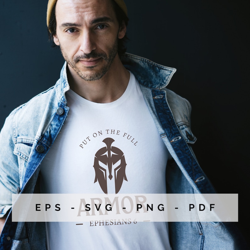 May include: White t-shirt featuring a brown Spartan helmet design and the words "PUT ON THE FULL ARMOR". The file types EPS, SVG, PNG, and PDF are printed below the graphic. The text "EPHESIANS 6" is printed below the file types.