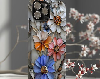 Puede incluir: Funda de teléfono inteligente con un diseño floral con flores blancas, naranjas, rosas y azules. La funda tiene un fondo gris con un patrón de mosaico. La funda del teléfono está sobre una superficie de madera blanca.