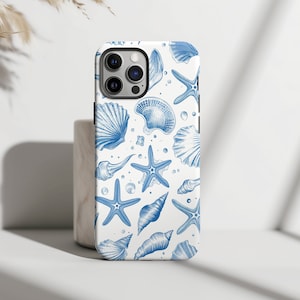 May include: A white phone case with a blue and white seashell and starfish pattern.