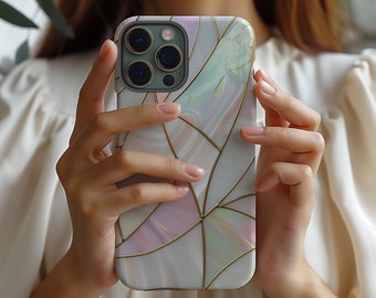 May include: A white phone case with a geometric pattern and gold accents. The case has a pearlescent finish and a camera lens cutout.