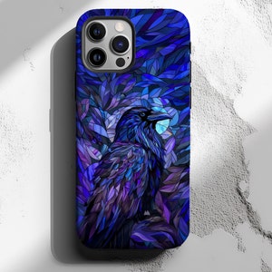 May include: A phone case with a stained glass design featuring a raven in a blue and purple colour scheme.
