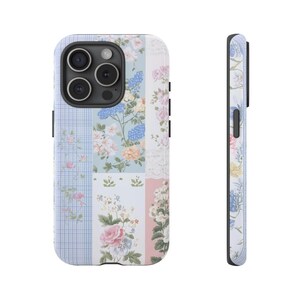 May include: A phone case with a patchwork design featuring floral patterns in shades of blue, pink, and white. The case has a clear back and a black border.