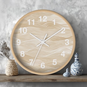May include: A round wall clock with a light wood frame. The clock face features a beige and white wave pattern with white numerals and hands. The clock is displayed on a wooden shelf with decorative items.