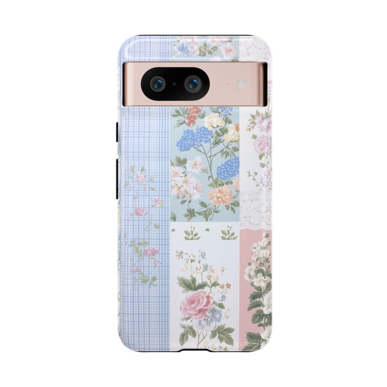 May include: A phone case with a floral patchwork design in shades of pink, blue, and white. The case has a raised camera bump with two lenses.