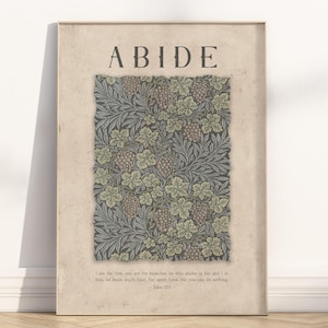 May include: A framed print with the word "ABIDE" at the top. The artwork features a central rectangular design with a pattern of grapes and leaves in shades of green, gray, and brown. A quote from John 15:5 is at the bottom.