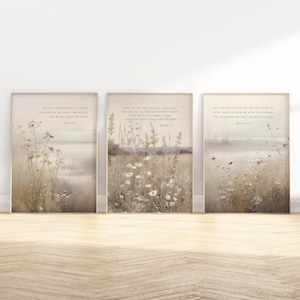 May include: Three framed prints with a neutral color palette. Each print features a field of wildflowers and text. The prints are displayed on a wooden floor against a white wall. The overall theme is nature and inspirational quotes.