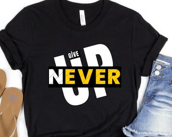 May include: Black t-shirt with white text that says "Give Up Never" in a bold, graphic font. The word "Never" is in a yellow box.