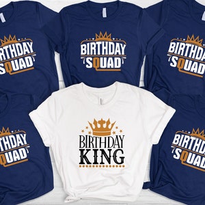 May include: Five navy blue t-shirts with a gold crown and the text "Birthday Squad" and one white t-shirt with a gold crown and the text "Birthday King".
