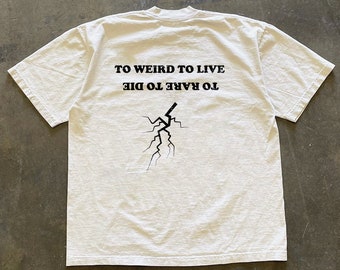 May include: White t-shirt with black text that reads "To Rare To Die To Weird To Live" and a black lightning bolt graphic.
