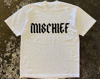May include: White t-shirt with black text that reads "MISCHIEF" in a gothic font.