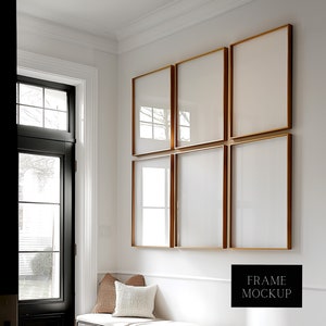 May include: Six gold picture frames with white mounts are arranged in a grid on a white wall. The frames are empty and ready for your photos or artwork.  FRAME MOCKUP