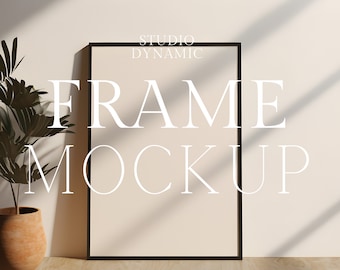 May include: A black frame mockup with the text "FRAME MOCKUP" and "STUDIO DYNAMIC" in white text. The frame is on a light beige wall with a potted plant in the foreground.