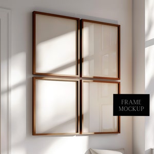 May include: Four brown wooden picture frames with white mats are arranged in a grid on a white wall. The frames are empty and ready for photos or artwork. The word "FRAME MOCKUP" is printed in black text on a white background in the lower right corner of the image.