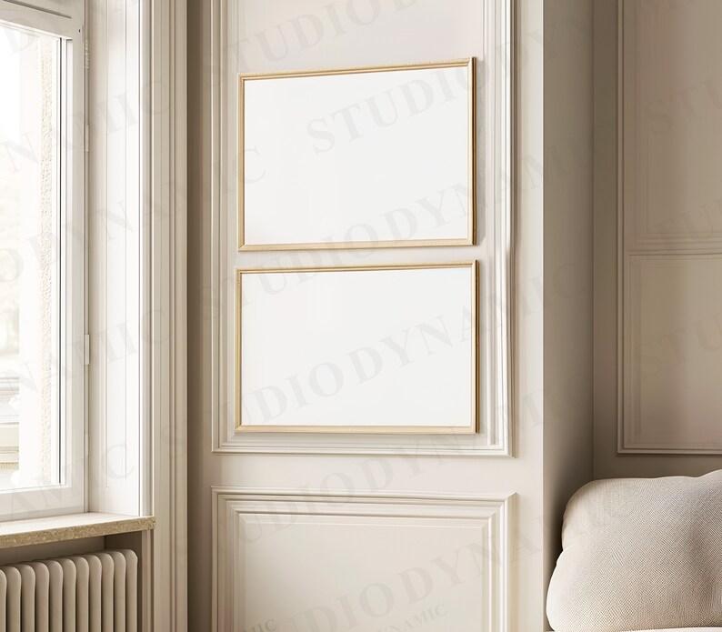 May include: Two gold framed blank canvases hanging on a white wall with ornate molding. The canvases are stacked vertically, with the top canvas slightly larger than the bottom canvas.