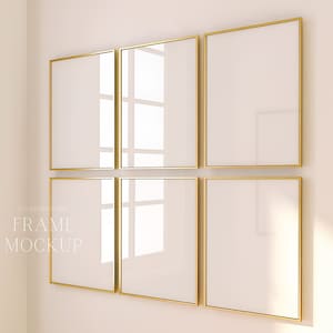 May include: Six gold picture frames are arranged in a grid on a white wall. The frames are empty and have a subtle reflection of the surrounding area.