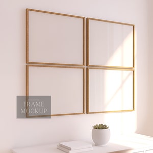 May include: Four empty picture frames with a natural wood finish are arranged in a square on a white wall. The frames are all the same size and have a simple, modern design. The frames are set against a white wall with a small potted succulent plant in the foreground.