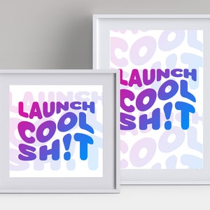 May include: Two framed prints with a white background and a gradient of pink, purple, and blue text that reads "LAUNCH COOL SH!T". The larger print has a pattern of the same text in a smaller size and a lighter shade of blue.