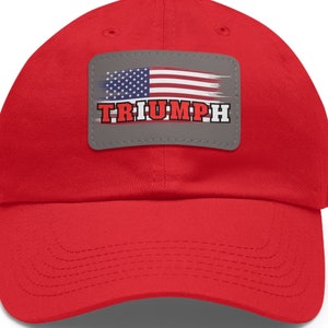 May include: Red baseball cap with a gray patch featuring an American flag and the word "TRIUMPH" in red letters.