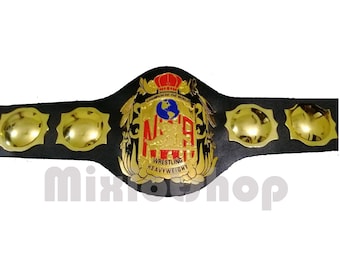 May include: A black wrestling championship belt with gold accents. The center plate features the text "NWA Wrestling Heavyweight" and a globe. The belt has gold plates on each side and the text "Champion of the World".