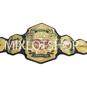 May include: A gold and black wrestling championship belt with intricate detailing. The belt features the text "WORLD CHAMPION" and "NWA" in a bold font. The design includes decorative elements and a central emblem.