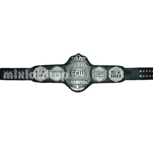 May include: A black leather wrestling championship belt with silver-colored metal accents. The center plate reads "WORLD GCW CHAMPION" and features a crown. Side plates display "GCW" and flags. The belt has a series of holes for adjustment.
