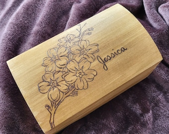 May include: A wooden box with a floral design and the name "Jessica" engraved on the lid.