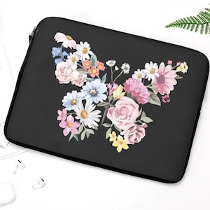 May include: Black laptop sleeve with a colorful floral design featuring a butterfly shape. The flowers are pink, white, yellow, and blue.