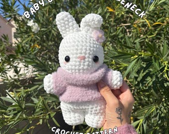 May include: A handmade white crochet bunny wearing a light purple turtleneck sweater. The bunny has black eyes and a pink nose. The text "Baby Bunny in Turtleneck" is arched above the bunny. The text "Crochet Pattern by Amiyabi" is below the bunny.