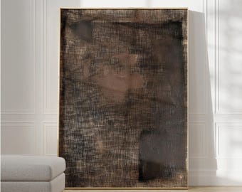 May include: Abstract painting with a textured, layered effect in shades of brown and black. The painting is framed in a thin, gold frame.