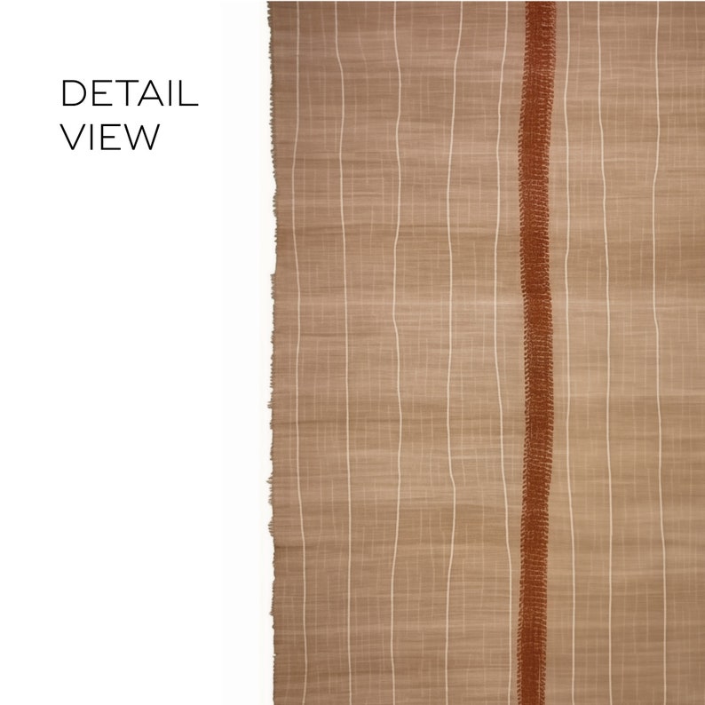 May include: Close-up detail of a woven fabric with a brown and white striped pattern. A thin, orange stripe runs vertically down the center of the fabric.