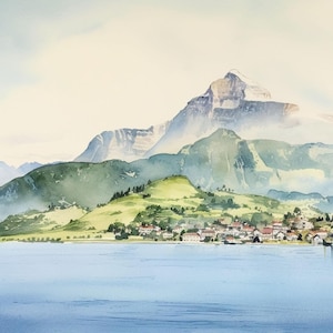 May include: Watercolor painting of a serene landscape featuring a village nestled on a green hillside, with a backdrop of majestic mountains and a calm lake. The artwork uses soft blues, greens, and whites.