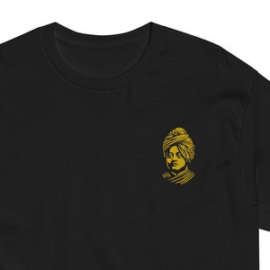 May include: Black t-shirt with a gold embroidered image of a man wearing a turban.