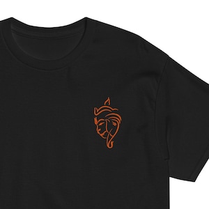 May include: Black t-shirt with an orange line drawing of a stylized elephant head on the left chest.