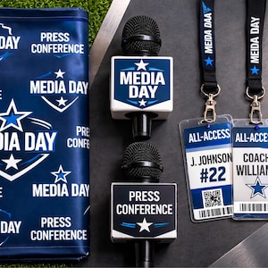 May include: An assortment of media day equipment, including two microphones with "MEDIA DAY" and "PRESS CONFERENCE" signs, lanyards, and all-access badges. The color scheme is navy blue and white, with a star graphic.