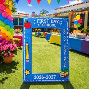 May include: A blue rectangular photo frame for the first day of school featuring white text that reads First Day of School, School Name Here, and 2026-2027. The frame is decorated with a red apple, a yellow pencil, a yellow star, and a stack of books.