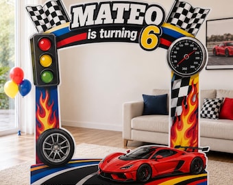 May include: A large racing-themed photo frame cutout featuring the text "MATEO is turning 6". The frame includes a traffic light, a speedometer, checkered flags, flames, a car wheel, and a red sports car at the base on a track design.