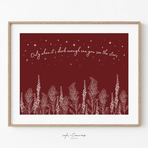May include: A maroon print with white floral illustrations and the quote "Only when it's dark enough can you see the stars".