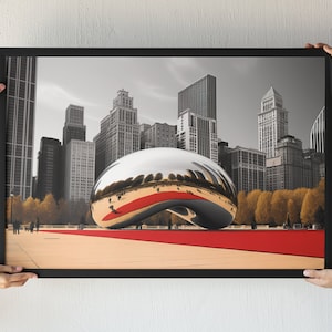 May include: A framed black and white photograph of a large, silver, bean-shaped sculpture in front of a city skyline. The sculpture is reflecting the city in its surface. The sculpture is on a red carpet in front of a row of trees.