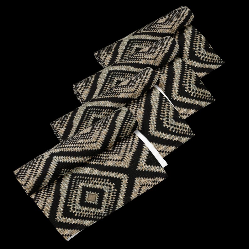 May include: A set of black and beige geometric patterned placemats. Each placemat features a repeating diamond design. The placemats are made of a woven material and have a square shape. The background is black.