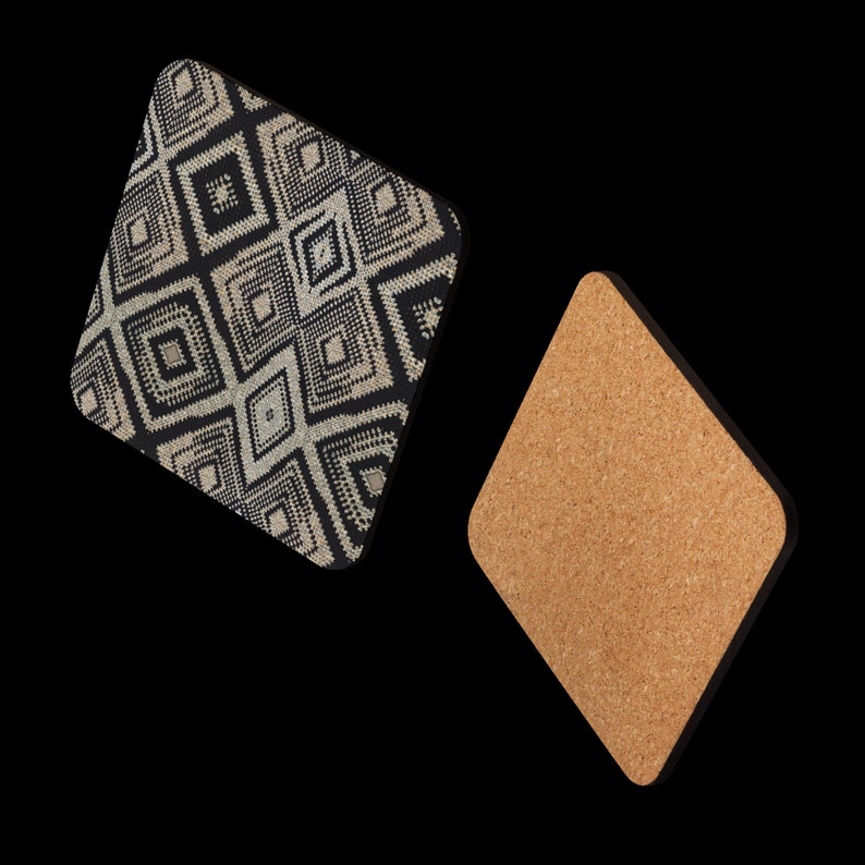 May include: Two diamond-shaped coasters. One coaster features a black and white geometric pattern. The other coaster is made of cork. The coasters are designed to protect surfaces from drink rings and heat.