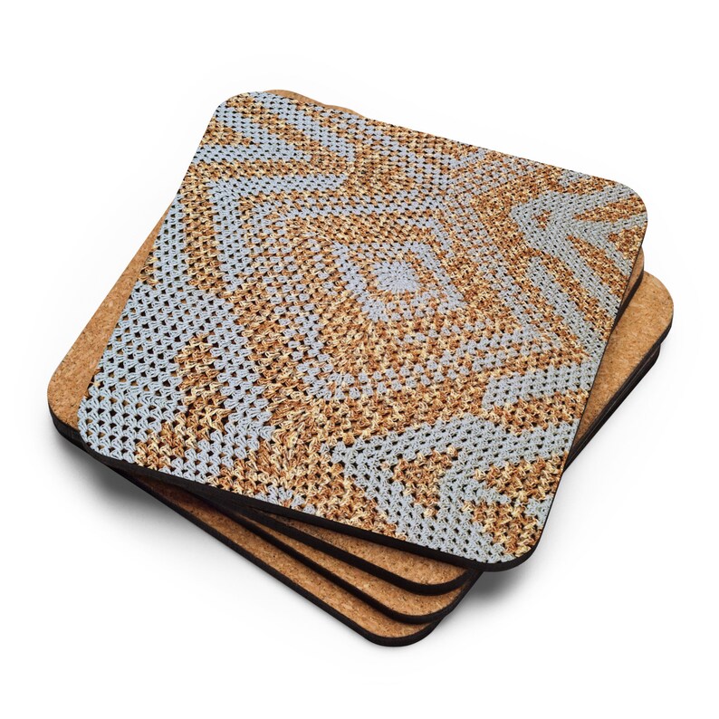 May include: Four square coasters with a cork base and a crocheted pattern in light blue, tan, and brown. The coasters are stacked at an angle. Each coaster has a side of approximately 10 cm.