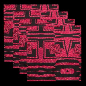 May include: Four folded black and red patterned cloth napkins. The napkins feature a geometric design with red and orange accents. The pattern is symmetrical and appears to be a woven or embroidered design. The napkins are stacked on top of each other.