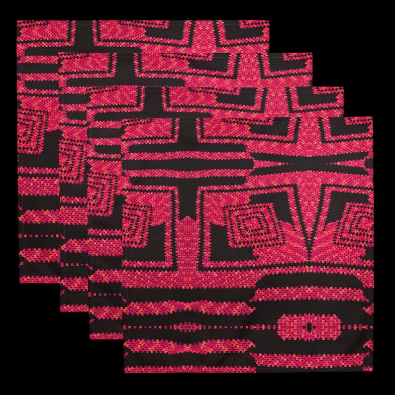 May include: Four folded black and red patterned cloth napkins. The napkins feature a geometric design with red and orange accents. The pattern is symmetrical and appears to be a woven or embroidered design. The napkins are stacked on top of each other.
