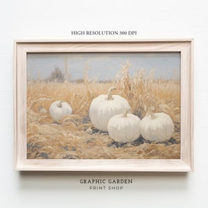 May include: A painting of a field of dried grass with four white pumpkins. The pumpkins are in the foreground of the painting, and the dried grass is in the background. The painting is framed in a light wood frame.
